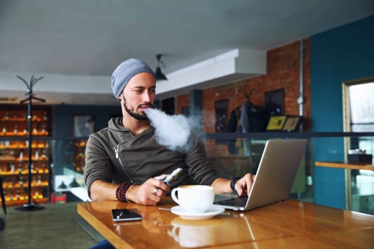 guy vaping and drinking coffee