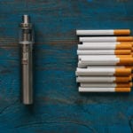 vape pen and pile of cigarettes