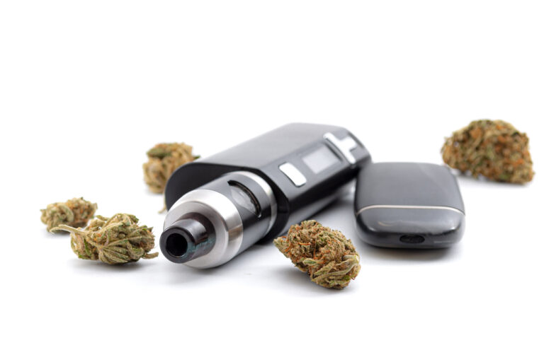 CBD and THC vaping products, dry herb vaporizer and healthy inhaling of cannabis concept theme with e-cigarette and vape mod surrounded by marijuana buds isolated on white background image